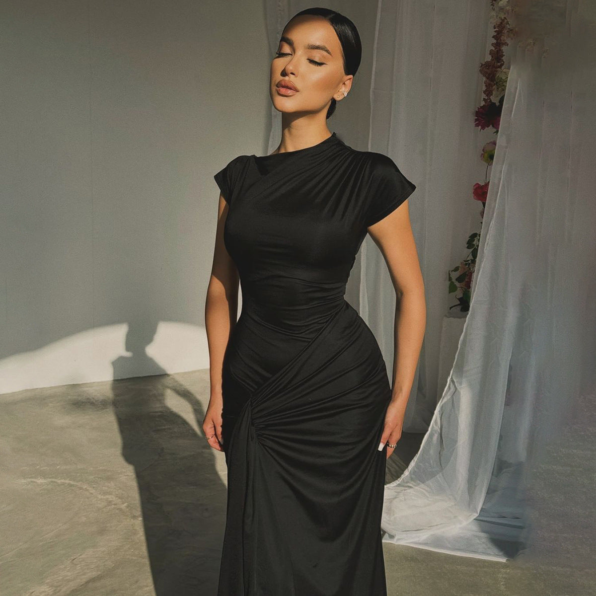 Séraphine satin maxi showing the long lean silhouette and knotted hip drape