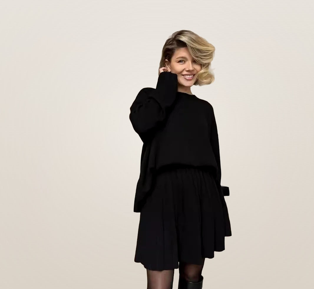 Capucine knit sweater and pleated skirt set in black, front view