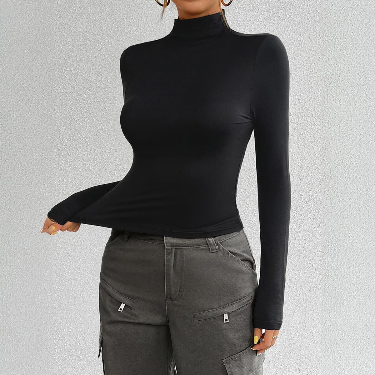 Mila mock neck top showing the close-to-body fit for layering under knits